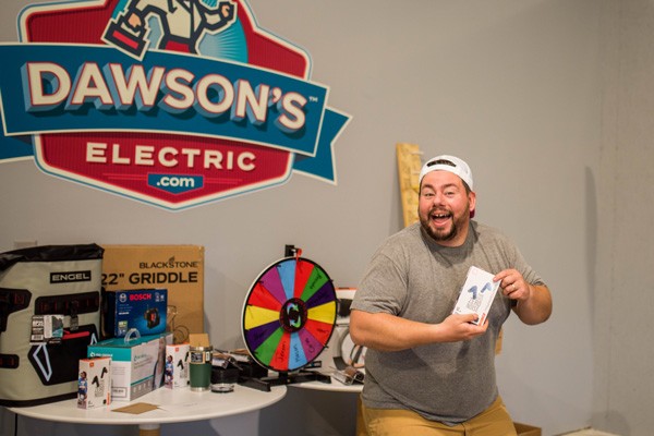 Employee posing with gift he won at company event